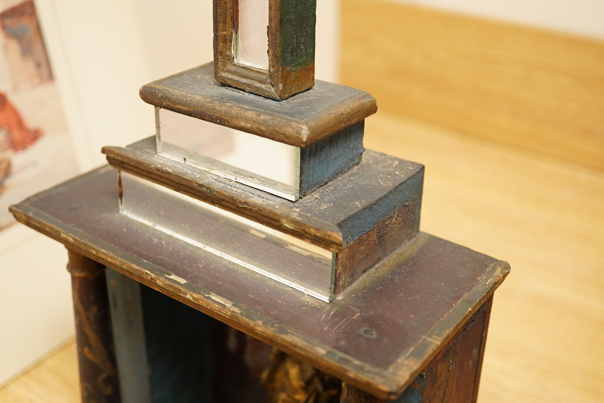 An early 19th century painted pine cross with mirrored front and a cast gilt metal statue of Mary and child, 78cm high